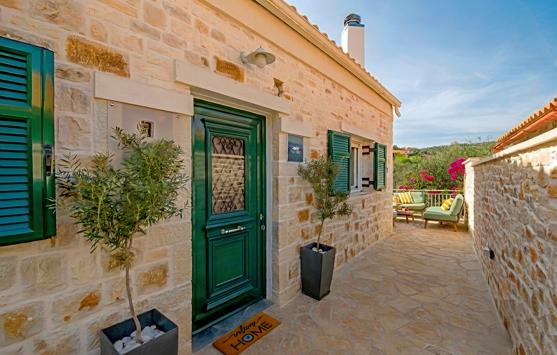 Stone facade and terrace entrance of Vive Mar Paxos in Gaios
